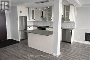 Toronto (Dorset Park) condo for rent - A kitchen with a refrigerator, oven, and cabinets.