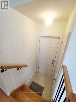 Pickering apartment for rent - A white door is in a hallway with a light on the ceiling.