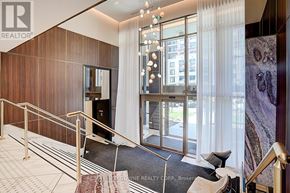 Oakville (Wm Westmount) condo for rent - A hallway with a staircase and a glass door leading to a balcony.