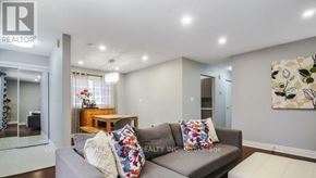 Toronto (Rouge) apartment for rent - A living room with a grey couch and a painting on the wall.