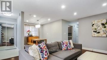 Toronto (Rouge) apartment for rent - A living room with a grey couch and a painting on the wall.