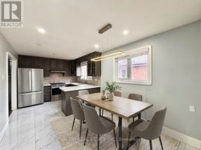 Brampton (Brampton North) apartment for rent - A spacious room with wooden flooring and a staircase on the right side.