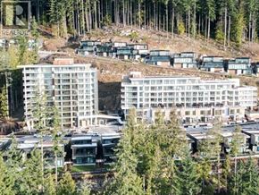 West Vancouver apartment for rent - A real estate development with multiple buildings surrounded by trees.