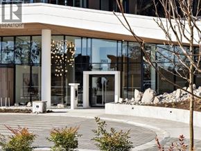 West Vancouver apartment for rent - A modern building with a glass facade and a sign that reads "REALTOR".