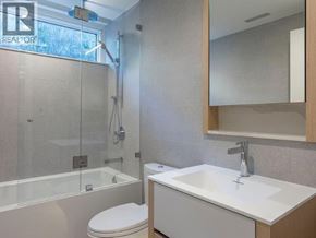West Vancouver apartment for rent - A bathroom with a toilet, sink, and bathtub.