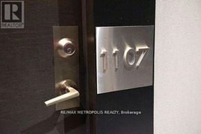 Toronto (Mimico) condo for rent - A door handle is on the left of a door with a metal plate on the right that says 1107.