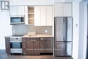 Toronto (Mimico) condo for rent - A kitchen with a refrigerator, sink, and cabinets.