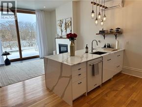 Paris apartment for rent - A kitchen with a large island and a view of a snowy landscape outside.