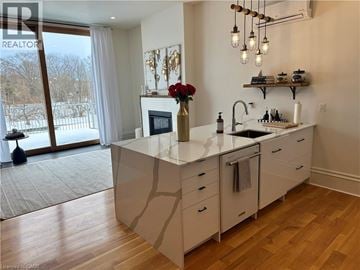 Paris apartment for rent - A kitchen with a large island and a view of a snowy landscape outside.