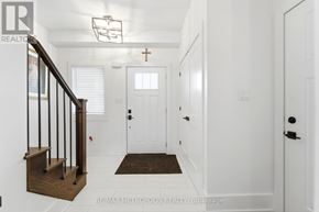 Welland (Lincoln/Crowland) apartment for rent - A hallway with a white door and a brown staircase.