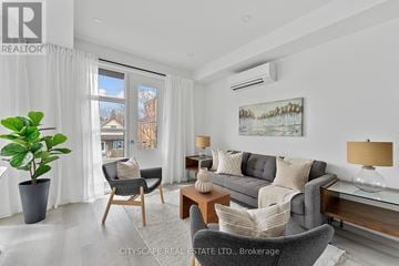 Toronto (Oakwood Village) townhouse for rent - A living room with a grey couch, a wooden table, and a painting on the wall.
