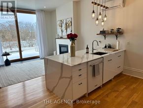 Brant (Paris) townhouse for rent - A kitchen with a large island and a view of a snowy landscape outside.