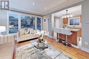 Toronto (Willowdale West) apartment for rent - A well-lit living room with a glass coffee table and a couch.