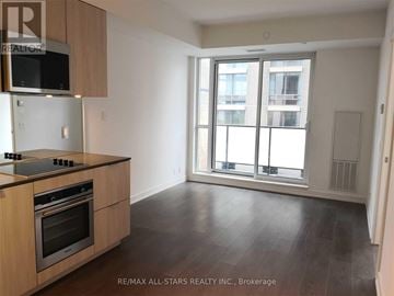 Toronto (Yonge-St. Clair) condo for rent - A kitchen with a stove top oven and microwave above it.