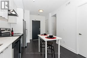 Burlington (Orchard) condo for rent - A modern kitchen with a dining table set for two.