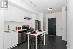 Burlington (Orchard) condo for rent - A white kitchen with a black fridge and stove.