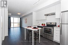 Burlington (Orchard) condo for rent - A modern kitchen with stainless steel appliances and a dining area.