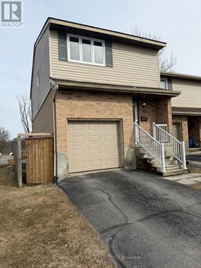 Kingston (West Of Sir John A. Blvd) townhouse for rent - A two-story house with a garage and a driveway.