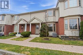 London North (North I) townhouse for rent - A house with a front yard and a tree in the front.