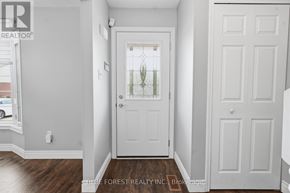 London North (North I) townhouse for rent - A white door with a glass window is in the middle of a hallway.