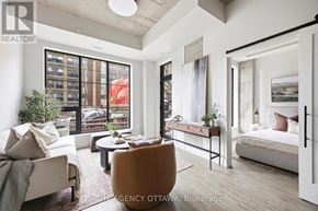 Ottawa condo for rent - A living room with a couch, chair, and a bed.