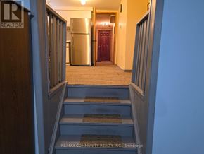 Toronto (Agincourt South-Malvern West) apartment for rent - A hallway with a staircase leading to a kitchen area.