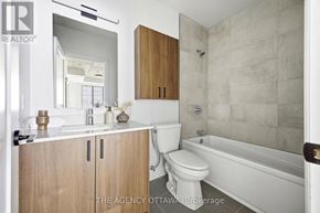 Ottawa condo for rent - A bathroom with a toilet, sink, and bathtub.