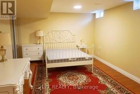 Markham (Victoria Manor-Jennings Gate) apartment for rent - A bedroom with a white bed, dresser, and rug.