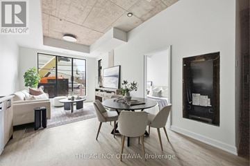 Ottawa condo for rent - A modern living room with a dining table and chairs.
