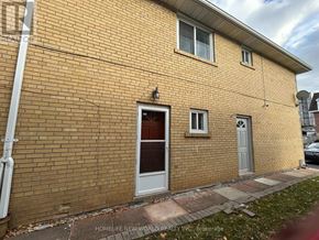 Toronto (Westminster-Branson) apartment for rent - A brick building with a grey door and windows.