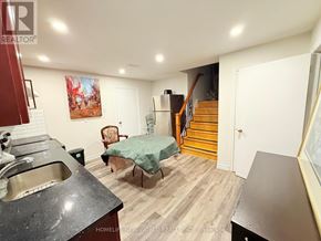 Toronto (Westminster-Branson) apartment for rent - A kitchen with a stainless steel sink and a dining table with chairs.