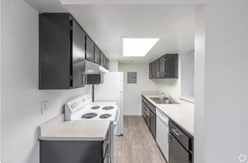Las Vegas apartment for rent - A small kitchen with a stove and a refrigerator.