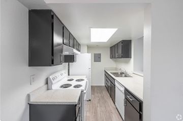 Las Vegas apartment for rent - A small kitchen with a stove and a refrigerator.