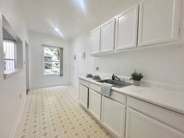 Los Angeles apartment for rent - A kitchen with white cabinets and a tiled floor.