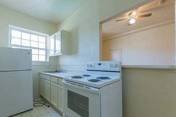 Los Angeles apartment for rent - A white kitchen with a stove and a refrigerator.