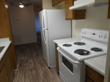 Boulder City apartment for rent - A kitchen with a white stove and refrigerator.