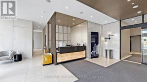 Toronto (Newtonbrook East) condo for rent - A modern office lobby with a reception desk and a large window.