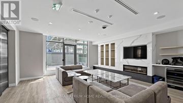 Toronto (Newtonbrook East) condo for rent - A modern living room with a glass table and a grey sofa.