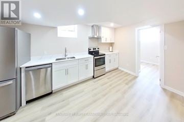 London North (North I) apartment for rent - A modern kitchen with white cabinets and stainless steel appliances.