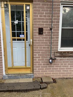 Toronto (Willowdale East) apartment for rent - A yellow door with a glass window and a sign on it.