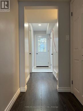 Toronto (Willowdale East) apartment for rent - A hallway with a white door and a wooden floor.