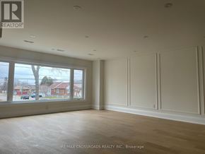 Toronto (Kennedy Park) apartment for rent - A room with a large window and wooden flooring.