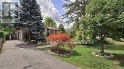 Richmond Hill (Crosby) apartment for rent - A residential area with a house, trees, and a driveway.