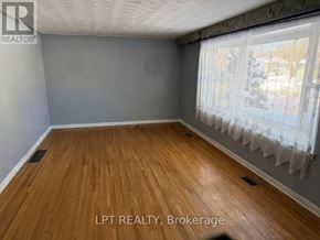 Richmond Hill (Crosby) apartment for rent - A room with wooden flooring and a window with curtains.