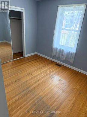 Richmond Hill (Crosby) apartment for rent - A room with wooden flooring and a window with curtains.