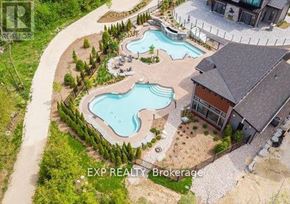 Blue Mountains condo for rent - A brokerage sign is displayed on an aerial view of a property with a swimming pool.