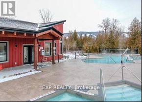 Blue Mountains condo for rent - A red building with a hot tub in front of it.
