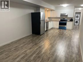 Maple Ridge apartment for rent - A kitchen with a black fridge, stove, and dishwasher.