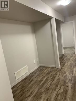 Maple Ridge apartment for rent - A room with wood flooring and white walls.