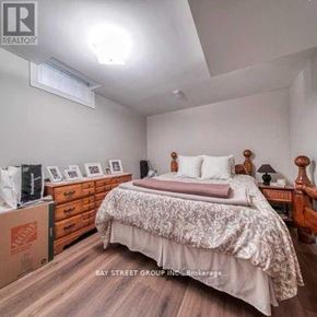 Markham (Rouge Fairways) apartment for rent - A bedroom with a bed, nightstand, and dresser.